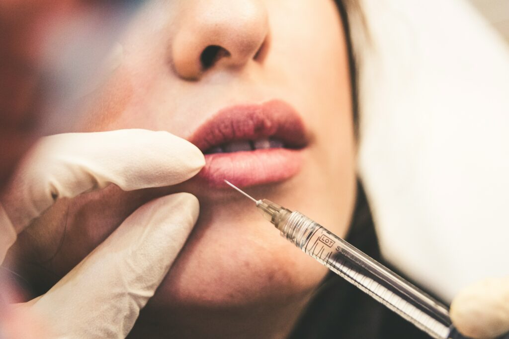 A healthcare professional in Santa Fe administers a neurotoxin injection to a client's lips, emphasizing precise cosmetic enhancement techniques.