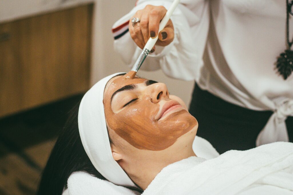 Woman receiving a chemical peel treatment at a spa in Santa Fe to improve her skin texture and appearance.