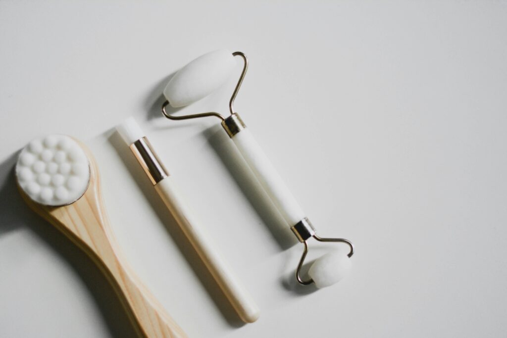 A jade roller on a spa table with greenery, symbolizing luxurious skincare tools used in Advanced Facials in Santa Fe for skin rejuvenation.