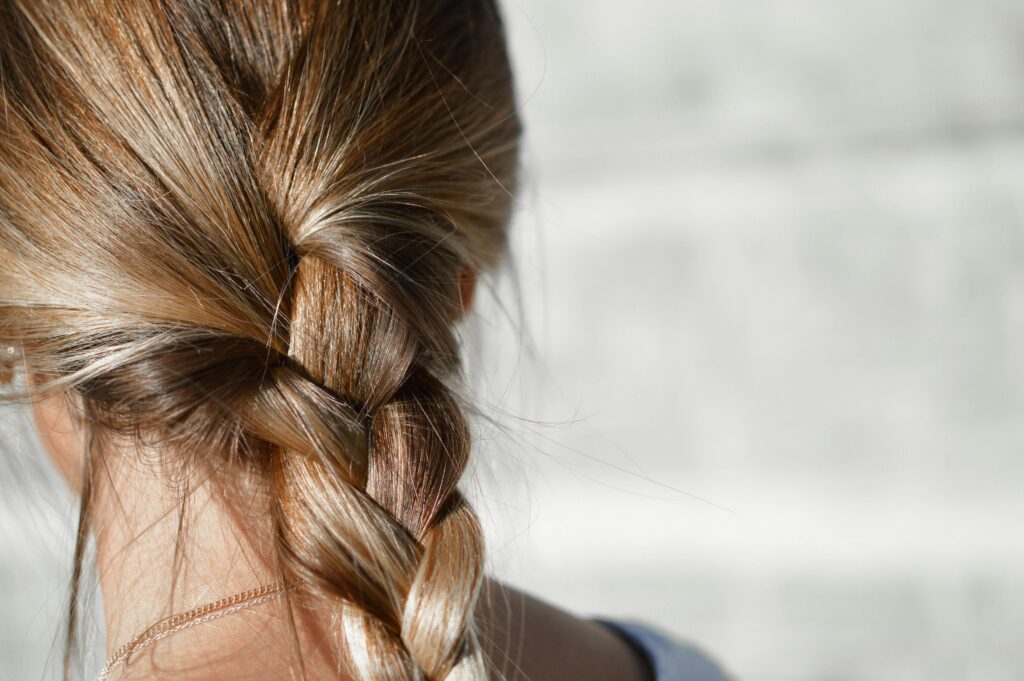 Close-up of a woman’s braid with healthy, thick hair, illustrating the potential benefits of PRP Therapy for hair loss at Seamless Skin MD in Santa Fe.