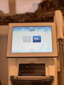 Close-up of BBL machine with touchscreen and handpiece in a Santa Fe treatment room at Seamless Skin M.D.