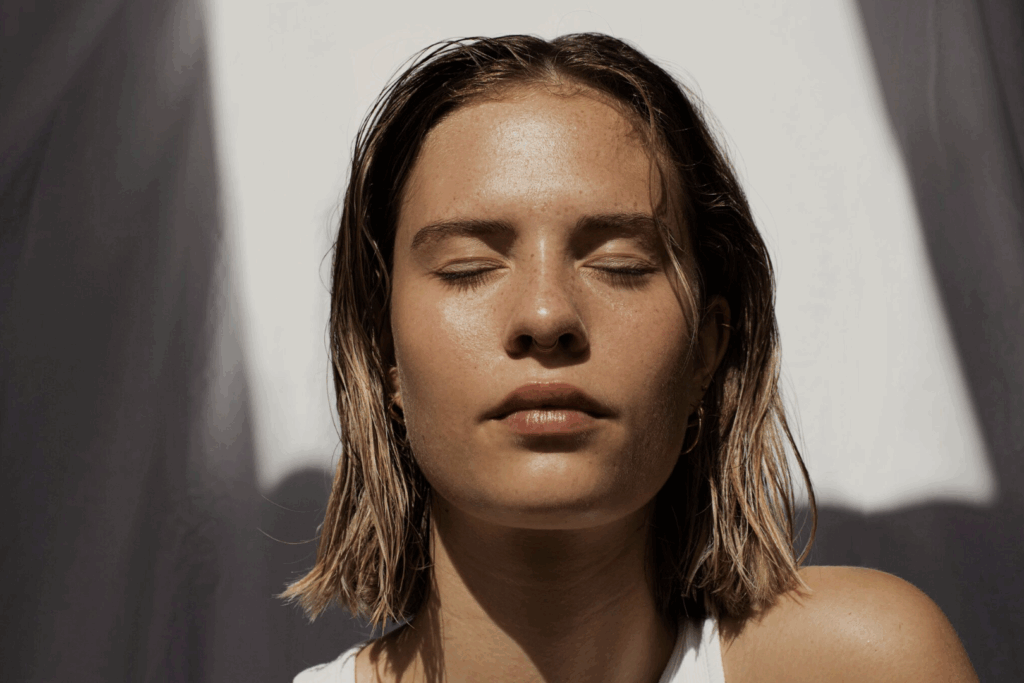 a woman with her eyes closed after a skin treatment.